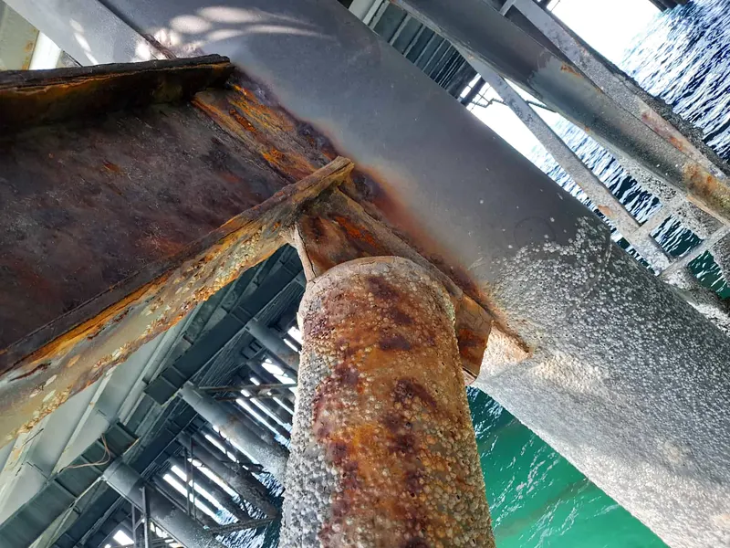 Heavily corroded steel members on an industrial structure